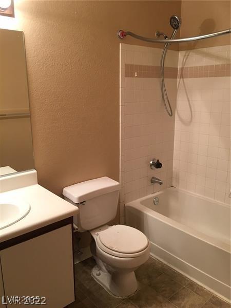 5220 Mission Carmel Ln Unit 207, Las Vegas, NV 89107 - full bath featuring a textured wall, vanity, toilet, and shower / washtub combination