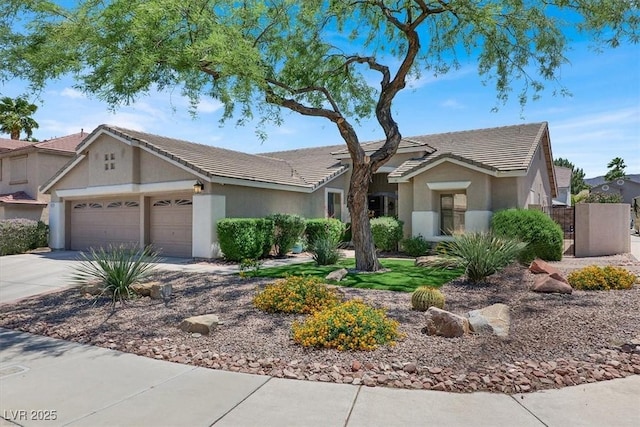 1763 Crystal Stream Ave, Henderson, NV 89012 - ranch-style home with an attached garage, driveway, stucco siding, and a tiled roof