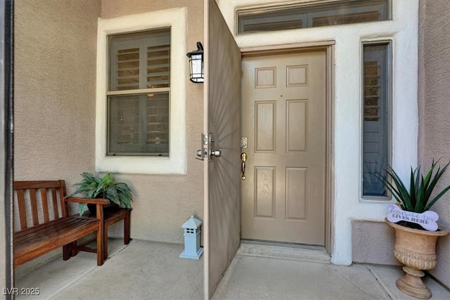 1763 Crystal Stream Ave, Henderson, NV 89012 - doorway to property with stucco siding and a porch