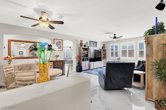 1763 Crystal Stream Ave, Henderson, NV 89012 - living room featuring a ceiling fan, arched walkways, and marble finish floors