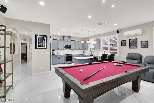 1763 Crystal Stream Ave, Henderson, NV 89012 - game room with a sink, light marble finish flooring, arched walkways, a wall mounted AC, and recessed lighting