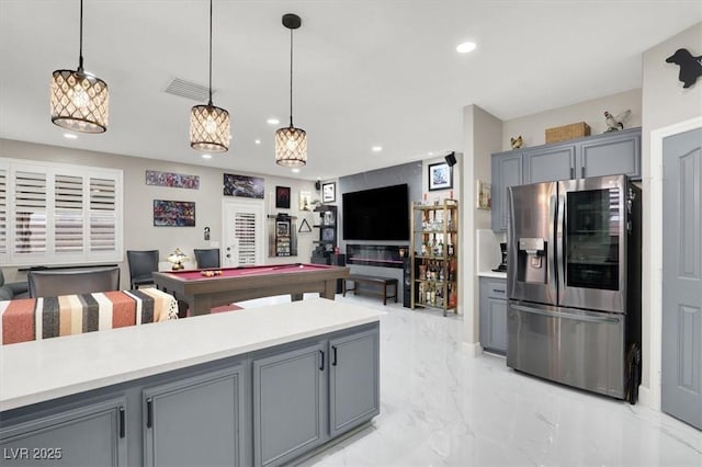 1763 Crystal Stream Ave, Henderson, NV 89012 - kitchen featuring stainless steel fridge with ice dispenser, gray cabinets, recessed lighting, light marble finish floors, and light countertops