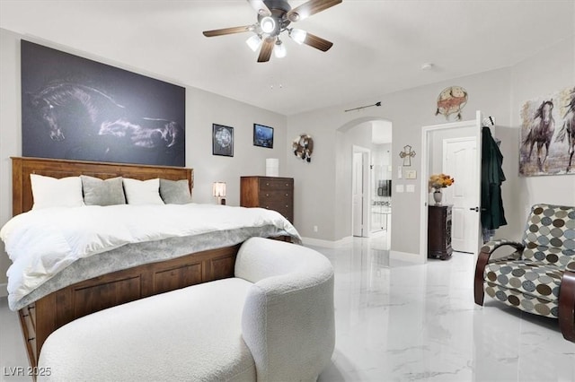 1763 Crystal Stream Ave, Henderson, NV 89012 - bedroom featuring light marble finish floors, arched walkways, ceiling fan, and baseboards