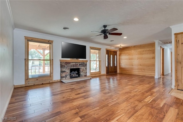 7950 Red Barn Dr, Las Vegas, NV 89123 - unfurnished living room with crown molding, healthy amount of natural light, ceiling fan, a stone fireplace, and baseboards