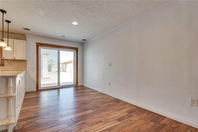 7950 Red Barn Dr, Las Vegas, NV 89123 - unfurnished living room with wood finished floors, crown molding, baseboards, a textured ceiling, and recessed lighting
