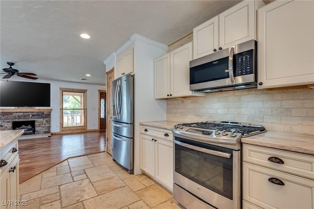 7950 Red Barn Dr, Las Vegas, NV 89123 - kitchen featuring appliances with stainless steel finishes, open floor plan, ceiling fan, decorative backsplash, and recessed lighting