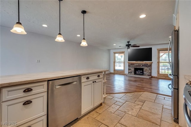 7950 Red Barn Dr, Las Vegas, NV 89123 - kitchen with appliances with stainless steel finishes, a ceiling fan, butcher block countertops, recessed lighting, and a fireplace