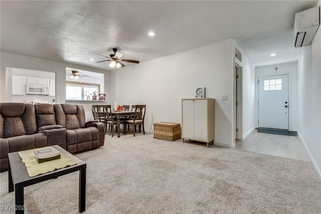 7950 Red Barn Dr, Las Vegas, NV 89123 - carpeted living room with a wall mounted air conditioner, ceiling fan, recessed lighting, baseboards, and a textured ceiling