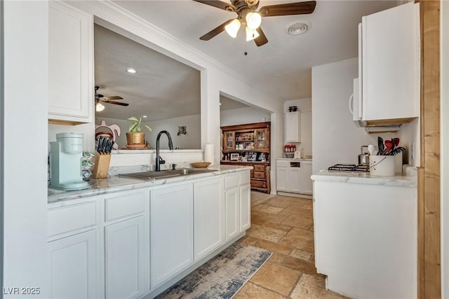 7950 Red Barn Dr, Las Vegas, NV 89123 - kitchen with stone tile flooring, ceiling fan, a sink, white cabinetry, and recessed lighting