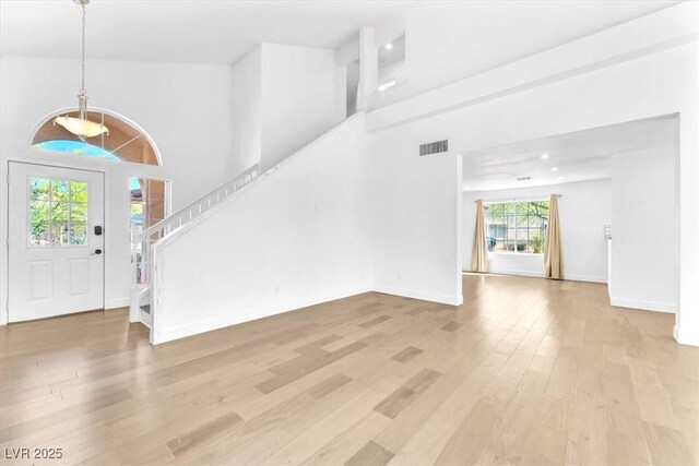5216 Desert Star Dr, Las Vegas, NV 89130 - entrance foyer featuring light wood-style flooring, stairs, baseboards, and a high ceiling