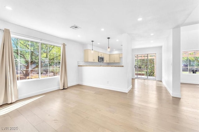 5216 Desert Star Dr, Las Vegas, NV 89130 - unfurnished living room featuring recessed lighting, healthy amount of natural light, baseboards, and light wood-style floors