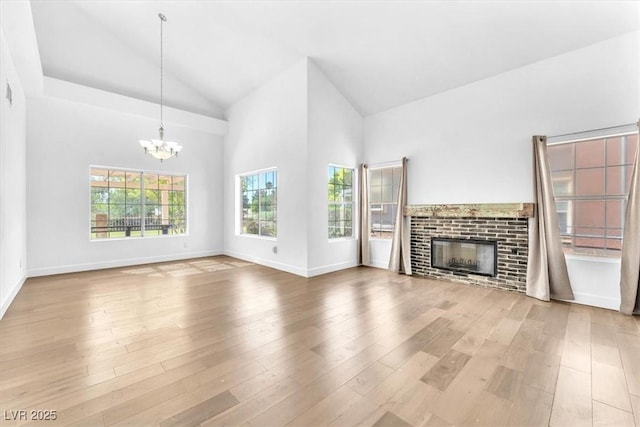 5216 Desert Star Dr, Las Vegas, NV 89130 - unfurnished living room with a chandelier, wood finished floors, baseboards, and high vaulted ceiling