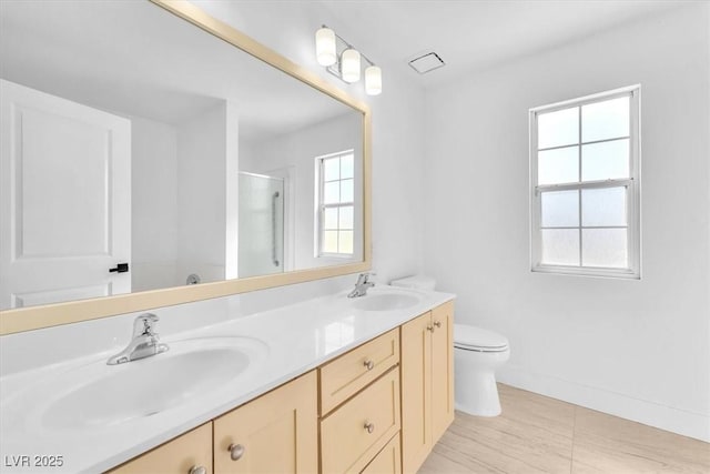 5216 Desert Star Dr, Las Vegas, NV 89130 - bathroom with double vanity, an enclosed shower, toilet, and baseboards