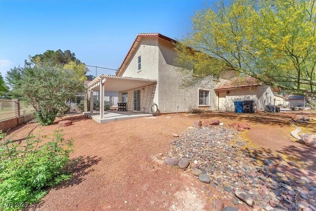 5216 Desert Star Dr, Las Vegas, NV 89130 - back of property featuring stucco siding, a pergola, a patio, and a tile roof