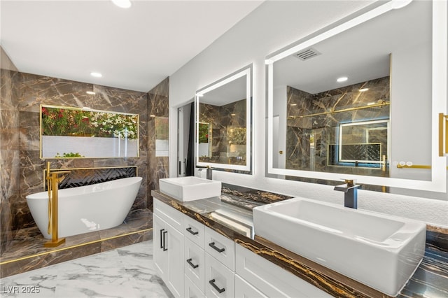 1616 Shadow Rock Dr, Las Vegas, NV 89117 - bathroom featuring marble tiled floors, double vanity, a freestanding bath, a marble finish shower, and recessed lighting