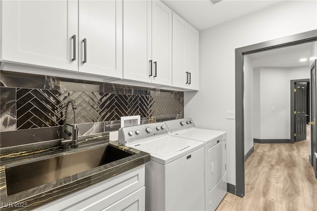 1616 Shadow Rock Dr, Las Vegas, NV 89117 - laundry area with separate washer and dryer, cabinet space, light wood-style floors, and baseboards