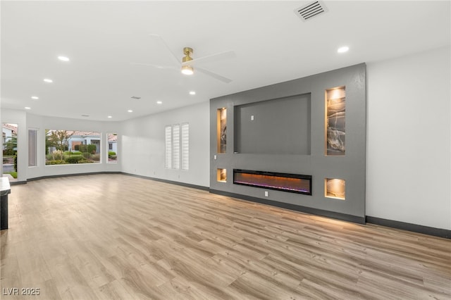 1616 Shadow Rock Dr, Las Vegas, NV 89117 - unfurnished living room with recessed lighting, wood finished floors, ceiling fan, baseboards, and a glass covered fireplace
