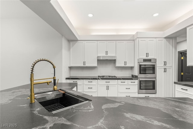 1616 Shadow Rock Dr, Las Vegas, NV 89117 - kitchen featuring a sink, appliances with stainless steel finishes, decorative backsplash, white cabinets, and recessed lighting