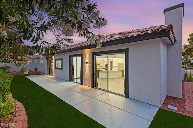 1616 Shadow Rock Dr, Las Vegas, NV 89117 - back of house at dusk with stucco siding, a patio, and a tile roof