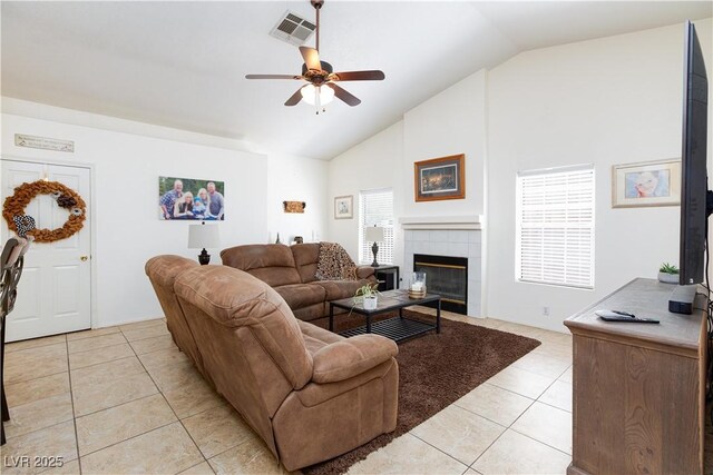 905 White Thunder St, Henderson, NV 89002 - living room with light tile patterned floors, a ceiling fan, a fireplace, and high vaulted ceiling