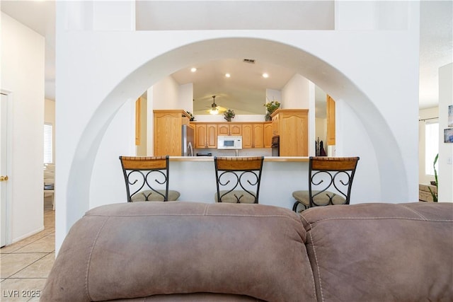 905 White Thunder St, Henderson, NV 89002 - living area with arched walkways, light tile patterned flooring, recessed lighting, high vaulted ceiling, and a ceiling fan