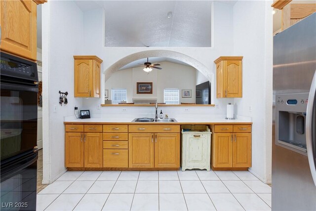 905 White Thunder St, Henderson, NV 89002 - kitchen featuring a sink, a ceiling fan, light countertops, stainless steel fridge, and a high ceiling