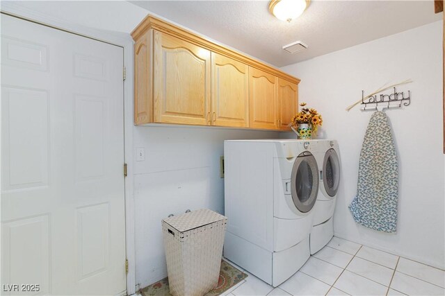 905 White Thunder St, Henderson, NV 89002 - laundry area with cabinet space, washer and dryer, and light tile patterned floors
