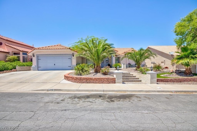 905 White Thunder St, Henderson, NV 89002 - mediterranean / spanish-style home with a tile roof, an attached garage, stucco siding, and driveway