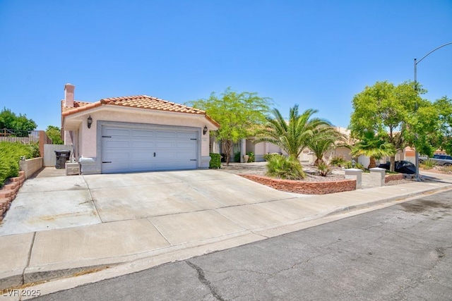 905 White Thunder St, Henderson, NV 89002 - mediterranean / spanish house featuring stucco siding, a tiled roof, a garage, and concrete driveway
