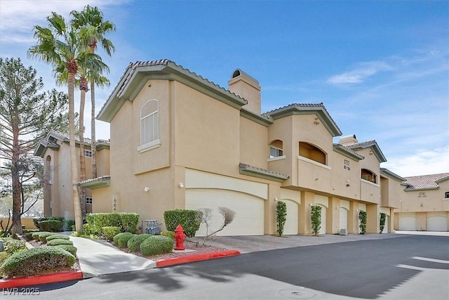 8737 Red Brook Dr Unit 201, Las Vegas, NV 89128 - view of property featuring a garage and driveway