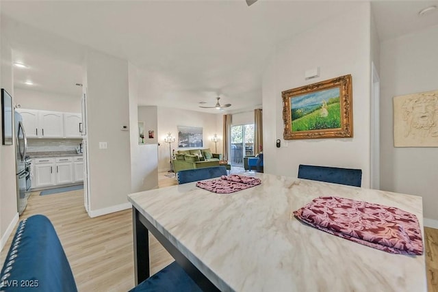 8737 Red Brook Dr Unit 201, Las Vegas, NV 89128 - dining space with light wood-style floors, a ceiling fan, and baseboards