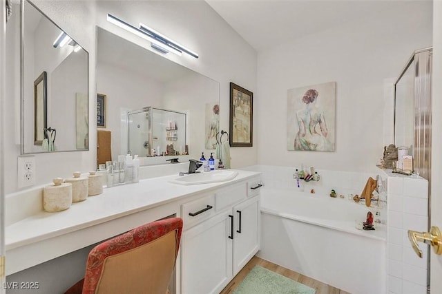 8737 Red Brook Dr Unit 201, Las Vegas, NV 89128 - bathroom with a shower stall, a garden tub, vanity, and wood finished floors
