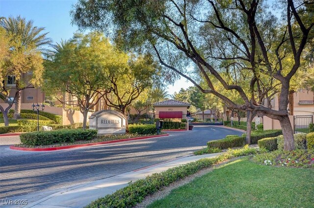 8717 Red Brook Dr Unit 201, Las Vegas, NV 89128 - view of asphalt road with curbs, sidewalks, and a gated entry