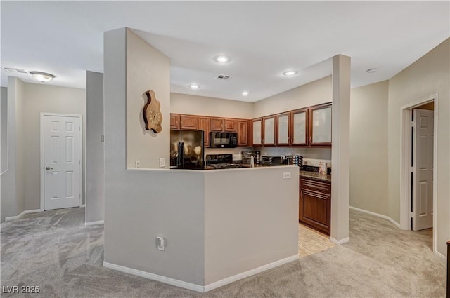 8717 Red Brook Dr Unit 201, Las Vegas, NV 89128 - kitchen featuring black appliances, light colored carpet, glass insert cabinets, baseboards, and brown cabinetry