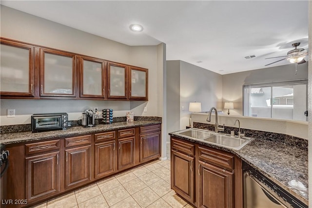 8717 Red Brook Dr Unit 201, Las Vegas, NV 89128 - kitchen with dishwasher, a sink, light tile patterned floors, a ceiling fan, and dark stone counters