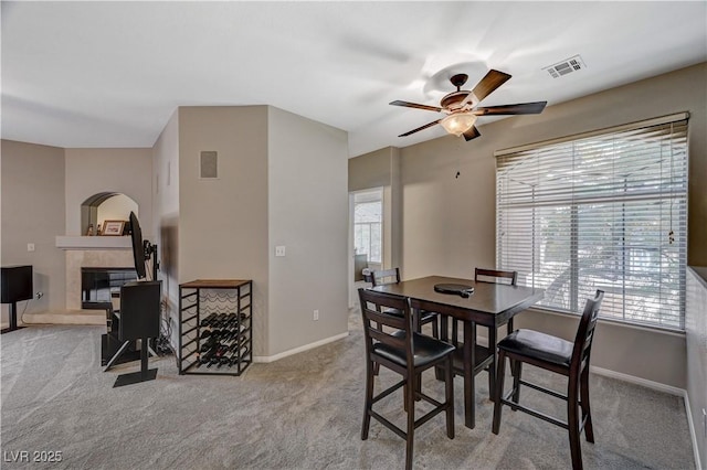 8717 Red Brook Dr Unit 201, Las Vegas, NV 89128 - carpeted dining room featuring a ceiling fan, a tile fireplace, and baseboards