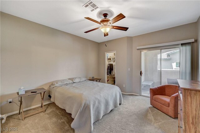 8717 Red Brook Dr Unit 201, Las Vegas, NV 89128 - bedroom featuring light colored carpet, access to exterior, a spacious closet, baseboards, and ceiling fan