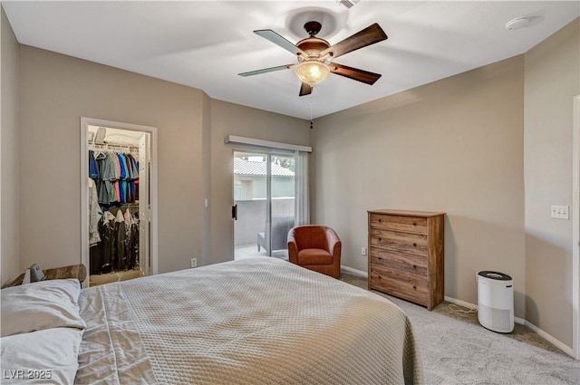 8717 Red Brook Dr Unit 201, Las Vegas, NV 89128 - bedroom with light carpet, a spacious closet, baseboards, and ceiling fan