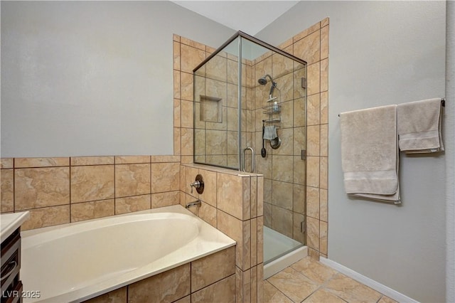 8717 Red Brook Dr Unit 201, Las Vegas, NV 89128 - full bathroom featuring a bath, a shower stall, baseboards, and vanity