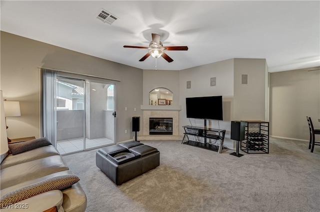 8717 Red Brook Dr Unit 201, Las Vegas, NV 89128 - living room featuring ceiling fan, carpet, a tiled fireplace, and baseboards