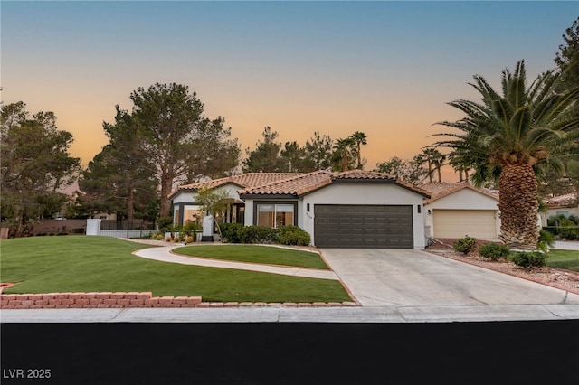 9029 Rivers Edge Dr, Las Vegas, NV 89117 - mediterranean / spanish home featuring stucco siding, a garage, a yard, concrete driveway, and a tiled roof