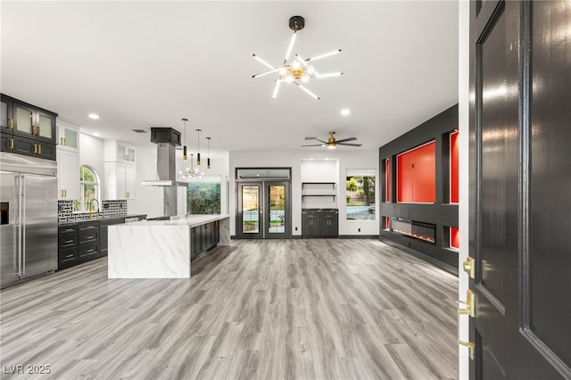 9029 Rivers Edge Dr, Las Vegas, NV 89117 - kitchen with a glass covered fireplace, built in refrigerator, a chandelier, plenty of natural light, and recessed lighting