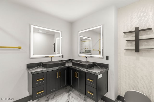 9029 Rivers Edge Dr, Las Vegas, NV 89117 - full bathroom with marble finish floors, double vanity, toilet, and baseboards