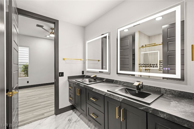 9029 Rivers Edge Dr, Las Vegas, NV 89117 - bathroom with double vanity, baseboards, a ceiling fan, recessed lighting, and marble finish flooring