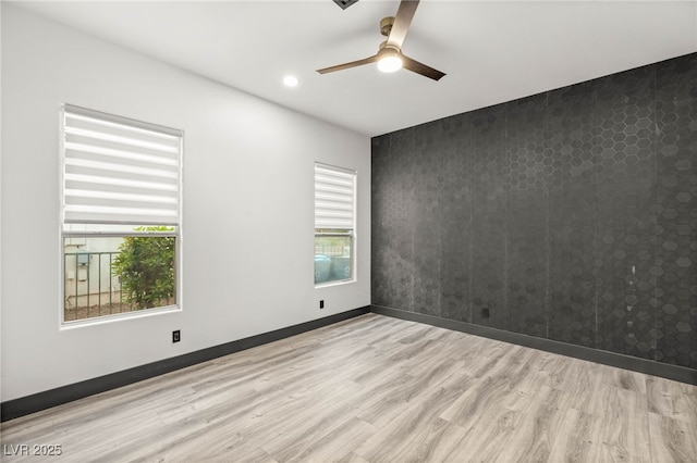 9029 Rivers Edge Dr, Las Vegas, NV 89117 - spare room with wood finished floors, a ceiling fan, baseboards, recessed lighting, and an accent wall