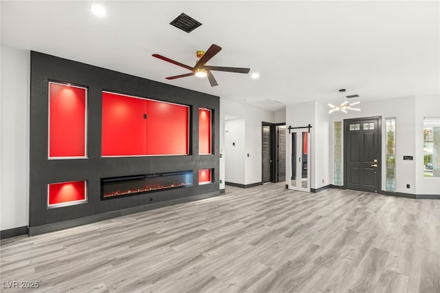 9029 Rivers Edge Dr, Las Vegas, NV 89117 - unfurnished living room with a barn door, ceiling fan, wood finished floors, baseboards, and recessed lighting