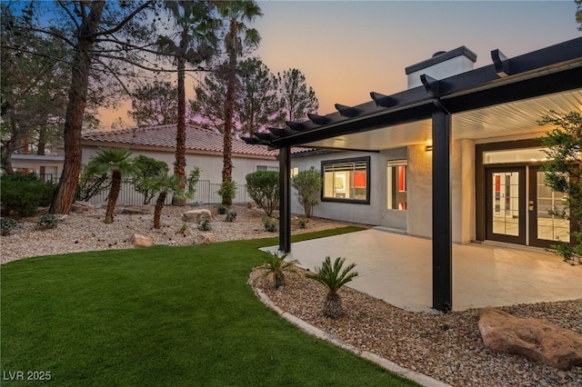 9029 Rivers Edge Dr, Las Vegas, NV 89117 - yard at dusk featuring a patio area and french doors