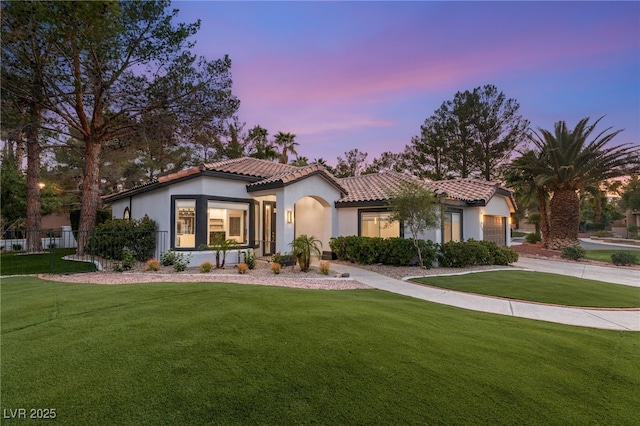 9029 Rivers Edge Dr, Las Vegas, NV 89117 - mediterranean / spanish-style house featuring a tile roof, a front lawn, stucco siding, and a garage