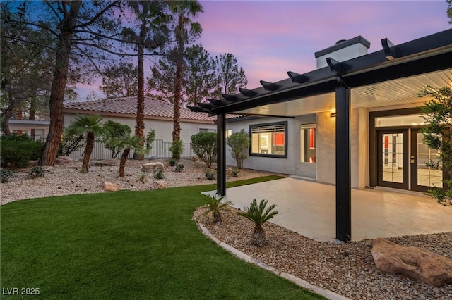 9029 Rivers Edge Dr, Las Vegas, NV 89117 - yard at dusk with a patio area and french doors