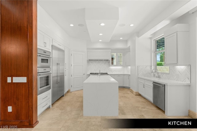 9101 Alta Dr Unit 102, Las Vegas, NV 89145 - kitchen featuring appliances with stainless steel finishes, a sink, an island with sink, light countertops, and recessed lighting